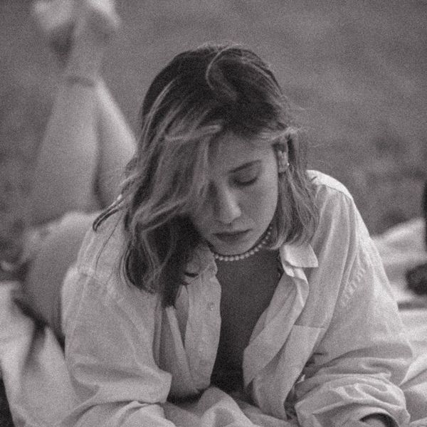 Silhouette of a woman stretching against a softly lit background.